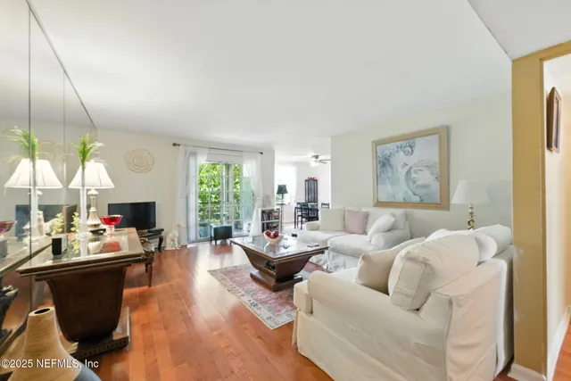 a living room with fireplace furniture and a large window