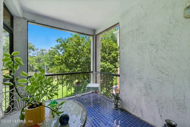 a view of a balcony with chair and table