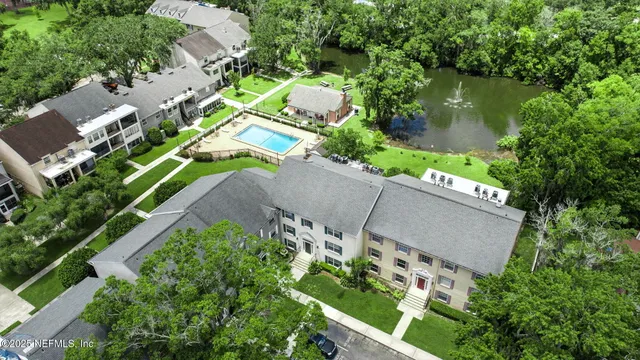 an aerial view of a house with a yard and outdoor seating