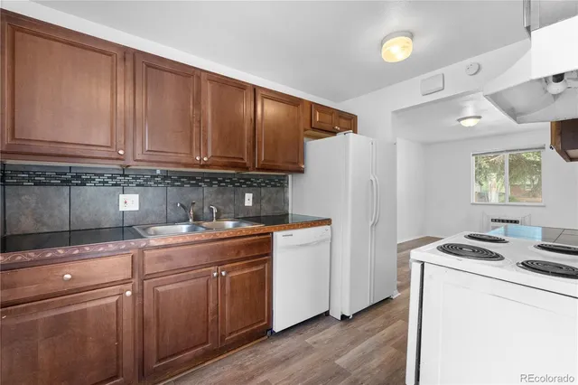 a kitchen with a white cabinets and white appliances