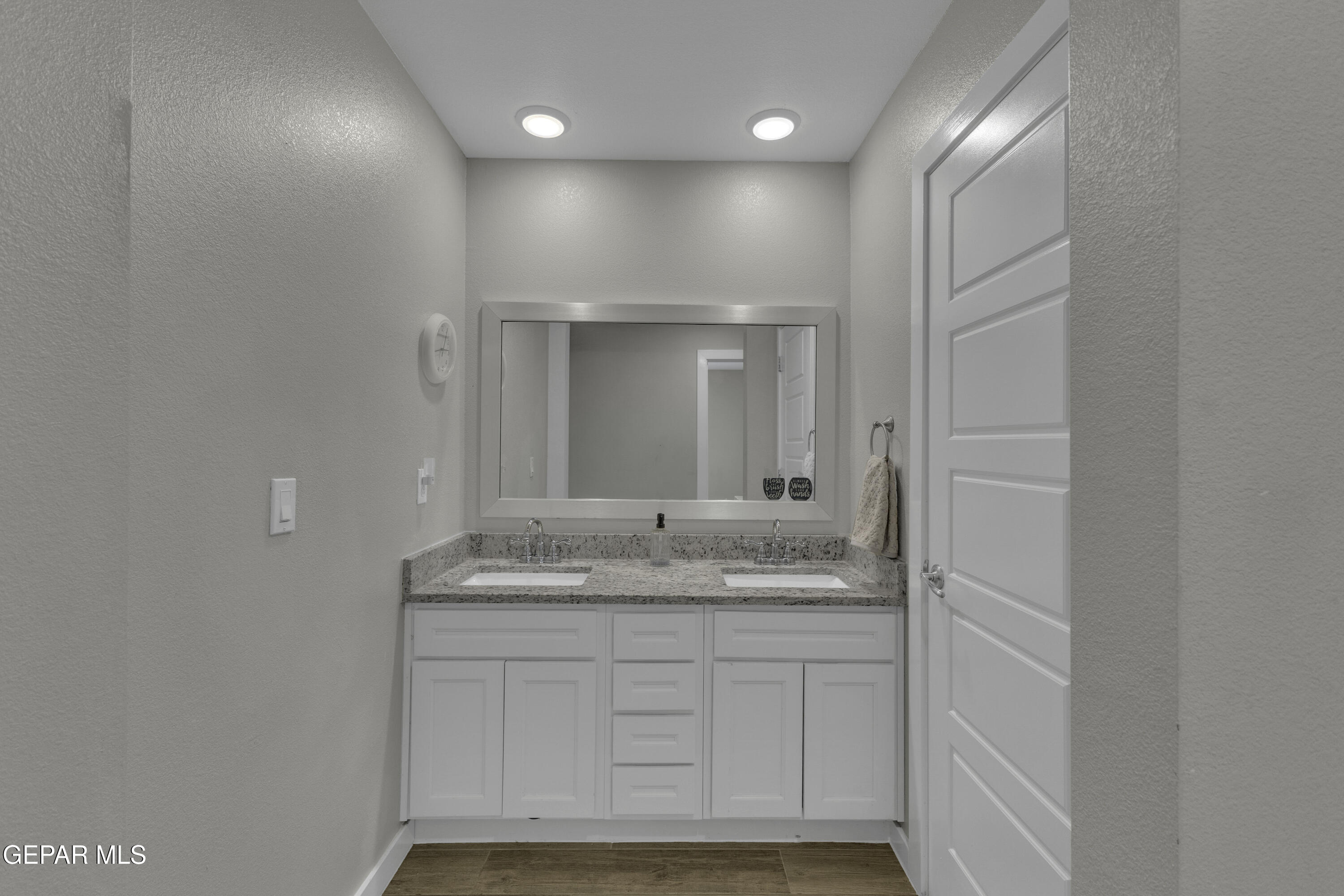 3529 Essence Street El Paso, TX 79938 - Photo 13 of 23 a bathroom with a sink and a mirror