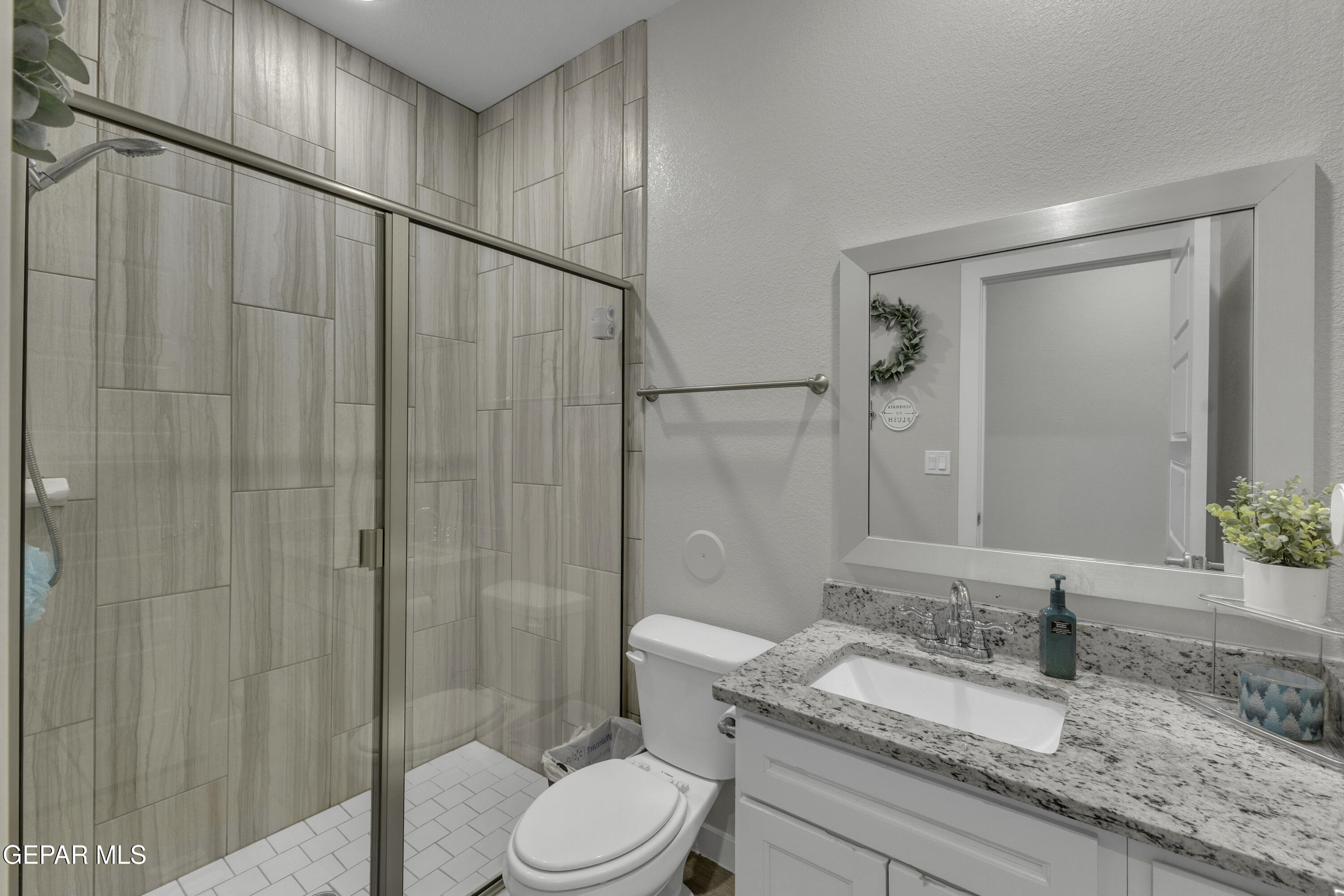 3529 Essence Street El Paso, TX 79938 - Photo 15 of 23 a bathroom with a granite countertop sink toilet and shower