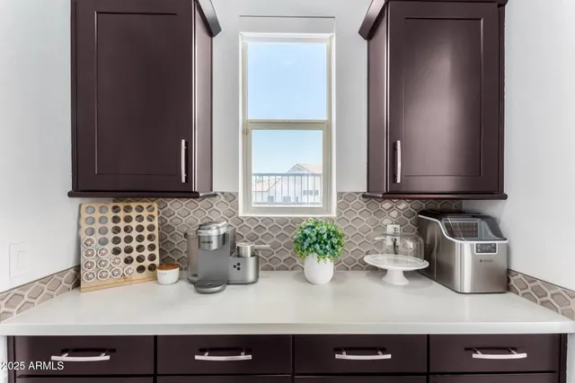 a kitchen with a sink and a potted plant