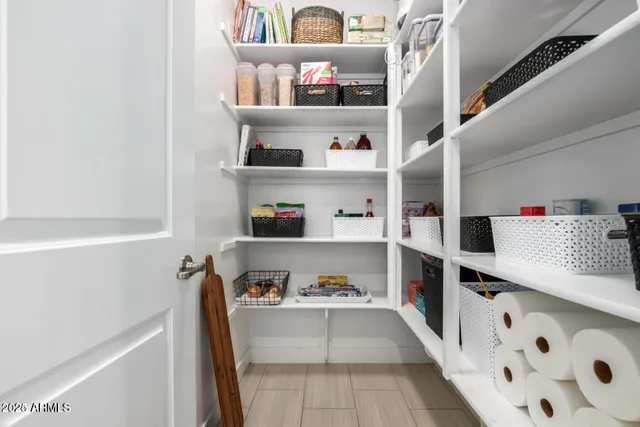 a view of walk in closet with clothes shoes and a cabinets
