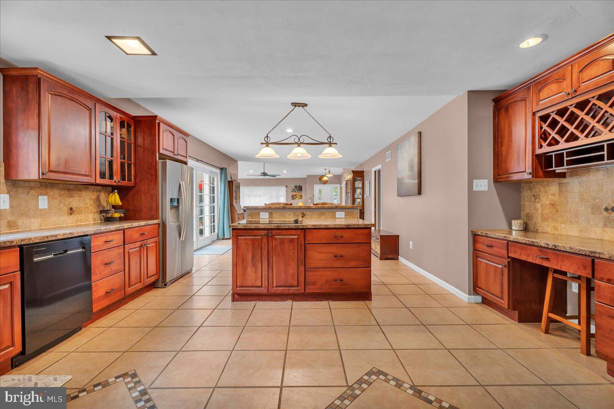 64 Blue Anchor Road Sicklerville, NJ 08081 - Photo 12 of 47 a large kitchen with stainless steel appliances granite countertop a stove a sink dishwasher and cabinets with wooden floor
