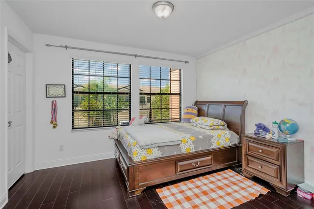 a bed sitting in a bedroom next to a window