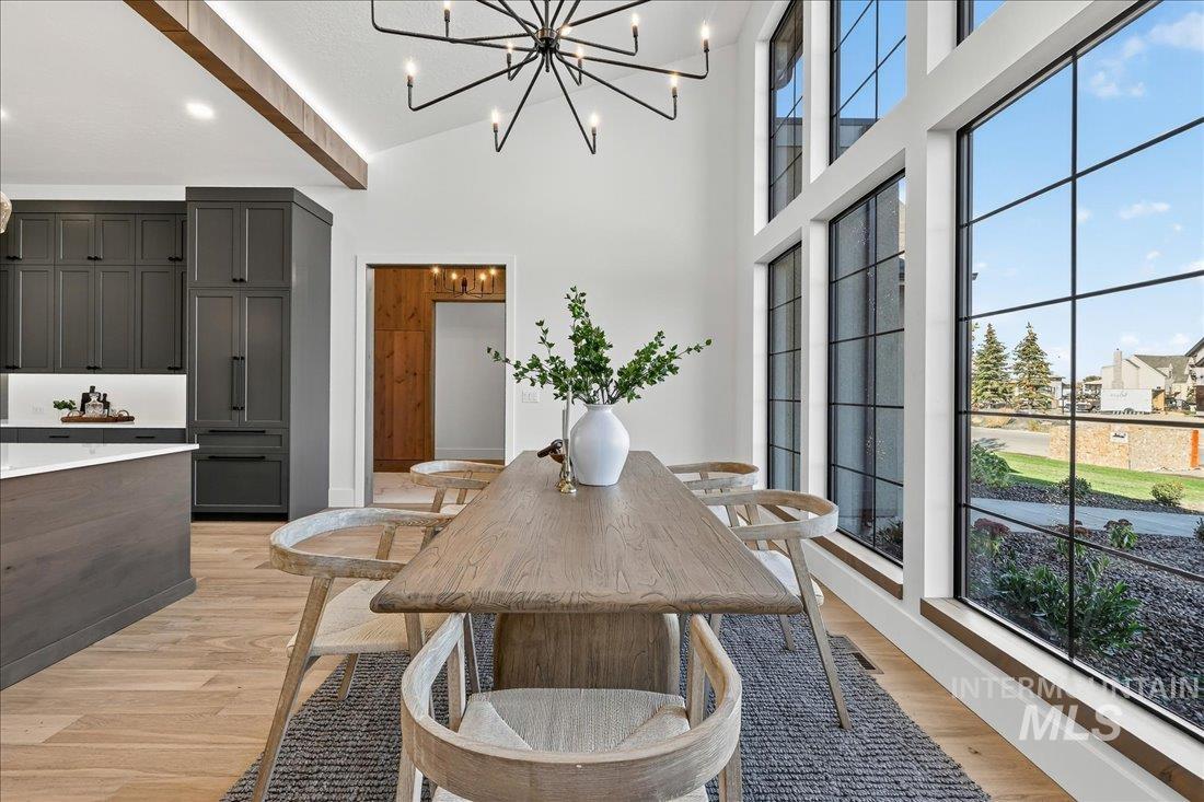 665 Watkins Street Middleton, ID 83644 - Photo 11 of 34 Dining area with light wood-style floors, a high ceiling, and a chandelier