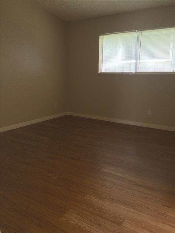 602 West 51st Street, Unit 101 Austin, TX 78751 - Photo 13 of 16 a view of an empty room with wooden floor and a window