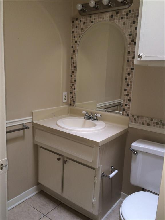 602 West 51st Street, Unit 101 Austin, TX 78751 - Photo 10 of 16 a bathroom with a sink mirror vanity and toilet