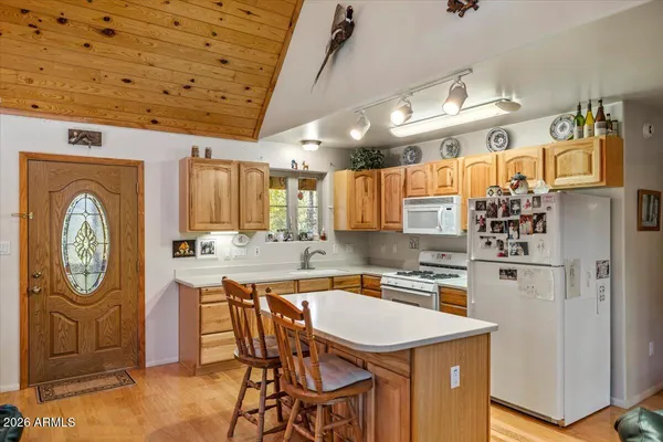 a living room with furniture a fireplace and a table