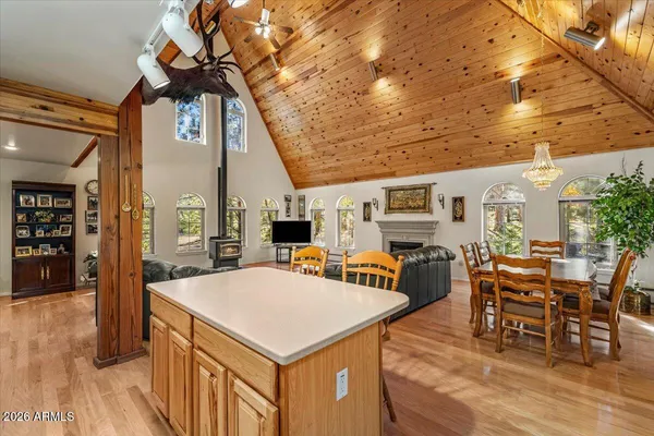 a kitchen with stainless steel appliances granite countertop a sink a stove and a refrigerator with wooden floor