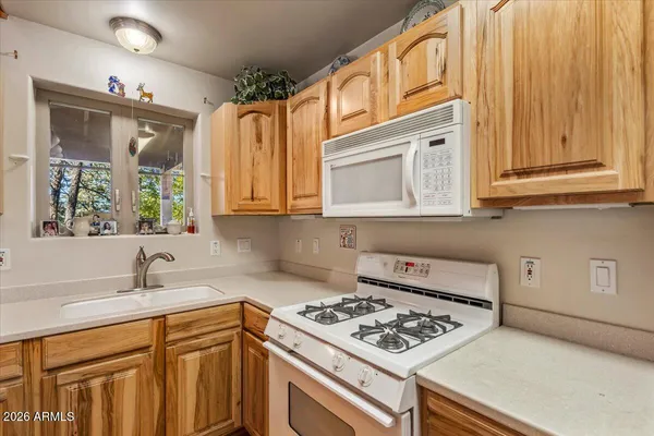 a kitchen with a sink a stove and chairs