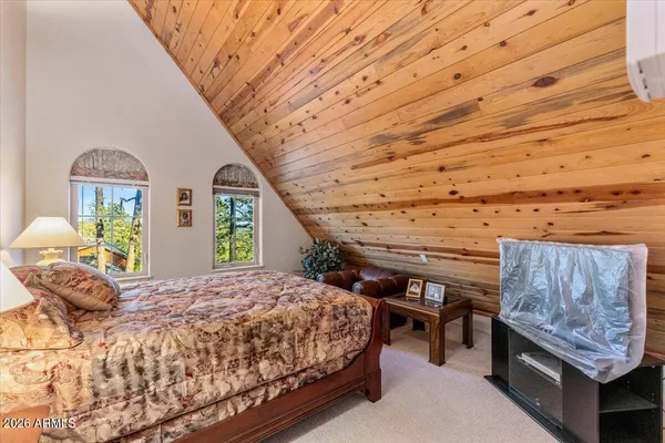 a bedroom with bed and window