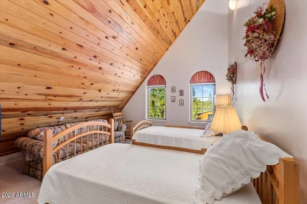 a bedroom with two beds and a window