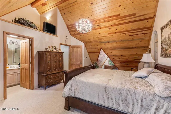 a bed room with a bed and a chandelier