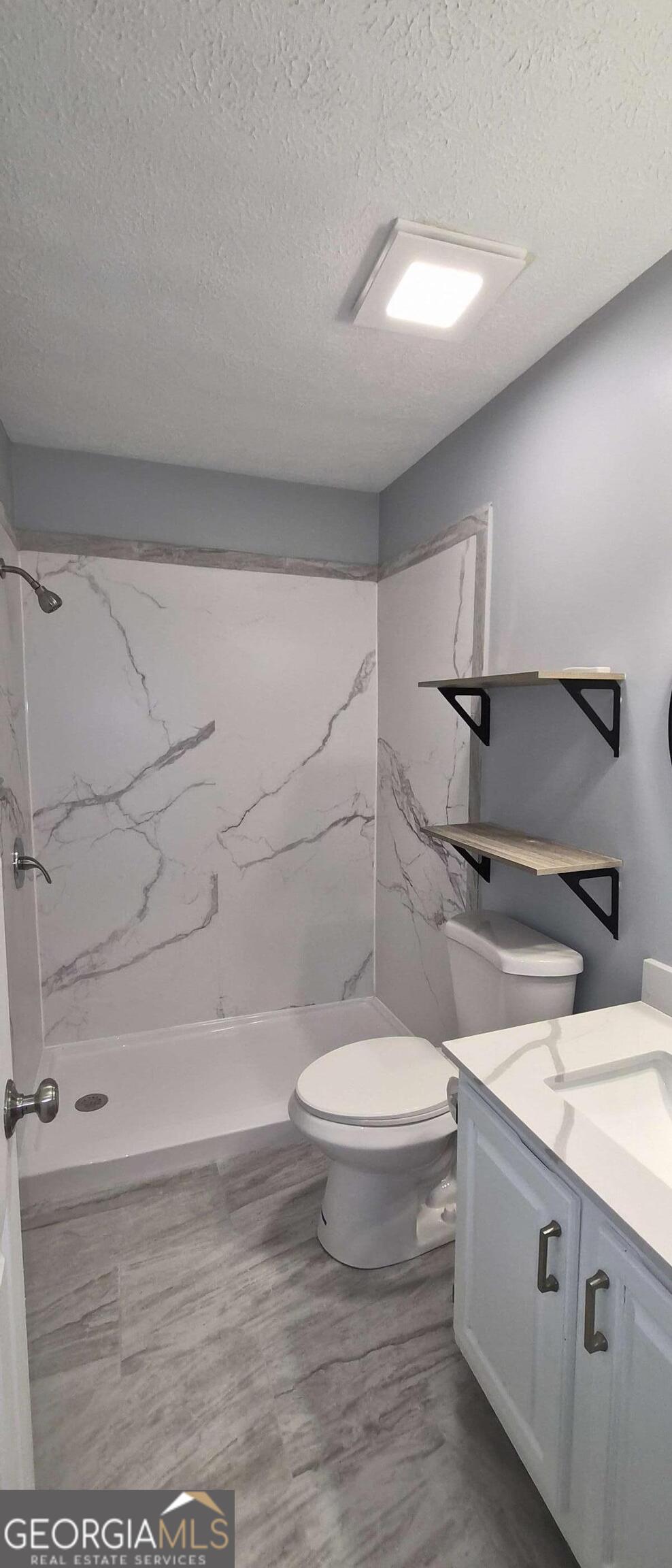 595 Macon Highway, Unit 5 Athens, GA 30606 - Photo 11 of 15 a bathroom with a sink a toilet and shower