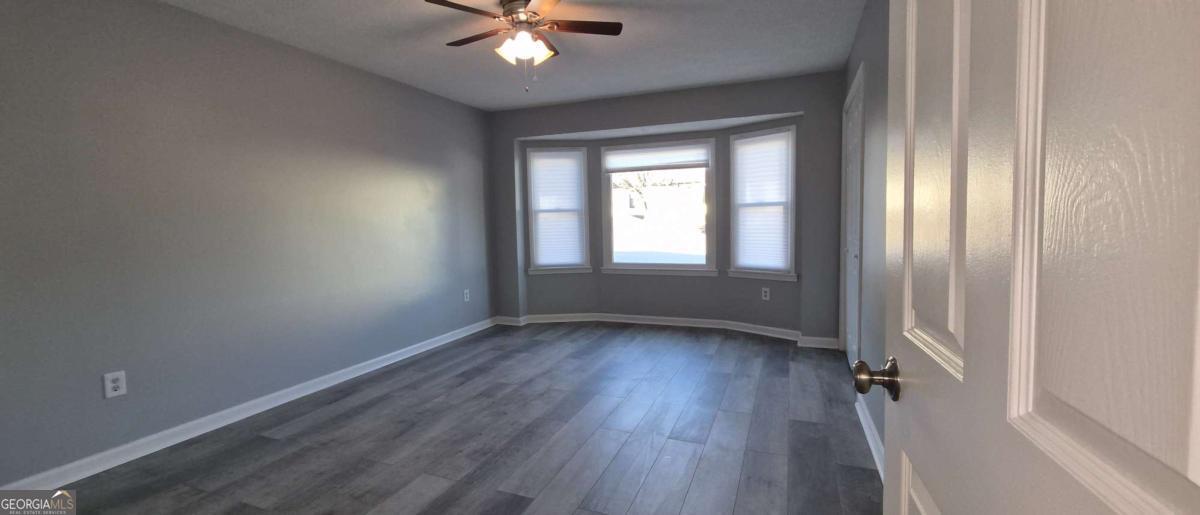 595 Macon Highway, Unit 5 Athens, GA 30606 - Photo 12 of 15 a view of an empty room with wooden floor and a window