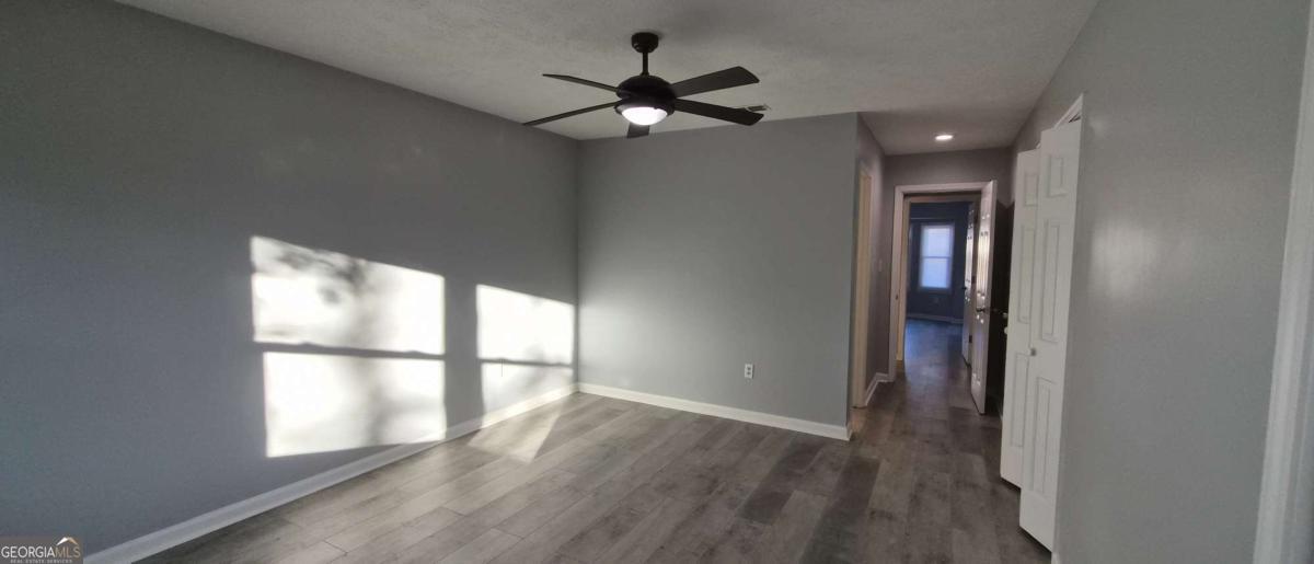 595 Macon Highway, Unit 5 Athens, GA 30606 - Photo 10 of 15 wooden floor in an empty room with a window