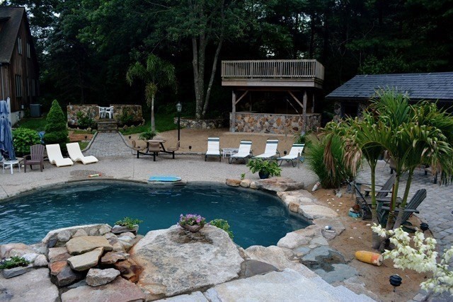 42 Pine Acres Road Foxboro, MA 02035 - Photo 4 of 40 a view of a swimming pool with a patio