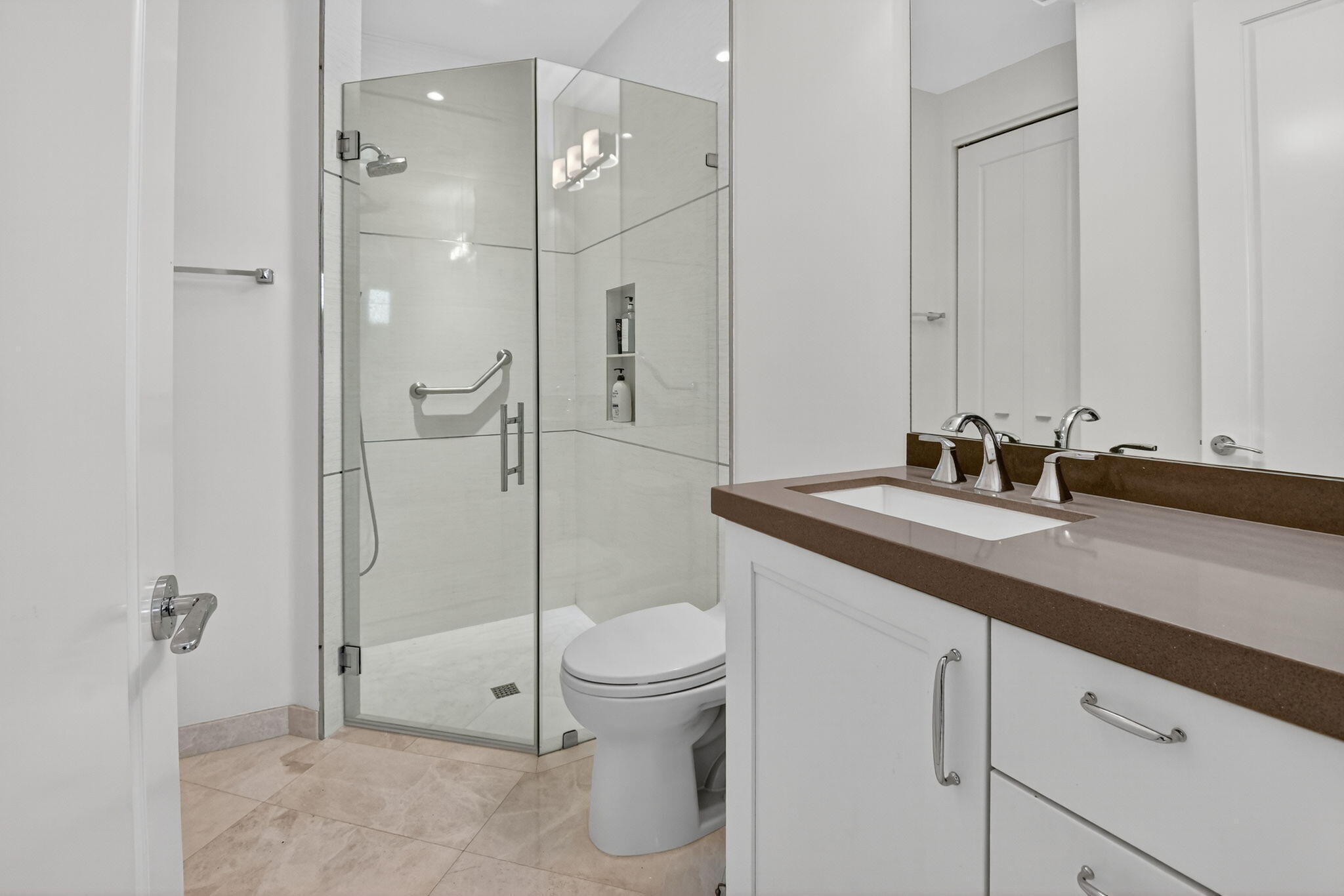 2563 Northwest 63rd Street Boca Raton, FL 33496 - Photo 34 of 65 a bathroom with a granite countertop sink toilet and shower