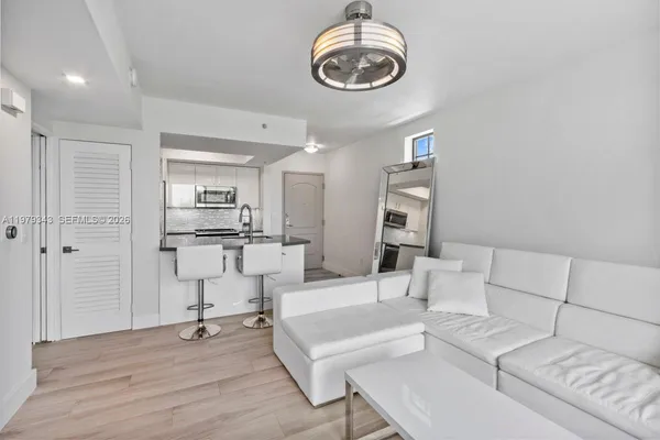 a kitchen with granite countertop a stove and a refrigerator