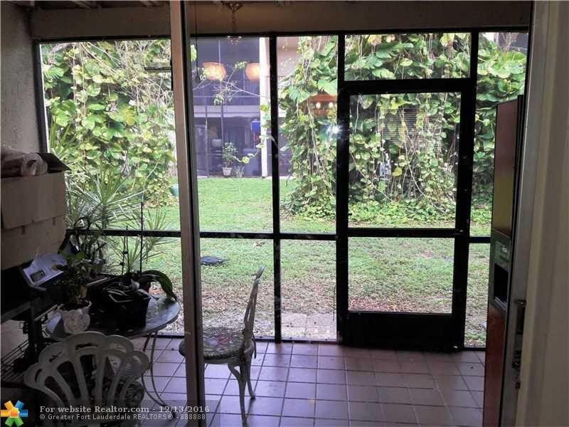 3316 Quail Close, Unit 21 Pompano Beach, FL 33064 - Photo 13 of 13 a view of a room with furniture and large windows