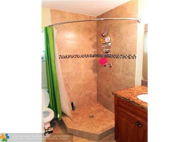 3316 Quail Close, Unit 21 Pompano Beach, FL 33064 - Photo 9 of 13 a bathroom with a shower and a sink