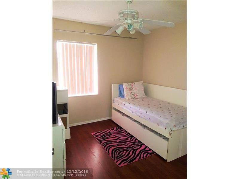 3316 Quail Close, Unit 21 Pompano Beach, FL 33064 - Photo 10 of 13 a bedroom with a bed and a window