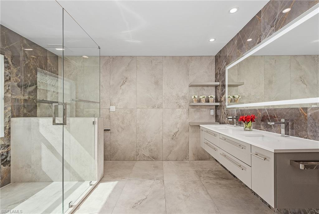 1601 Weybridge Circle, Unit 11 Naples, FL 34110 - Photo 11 of 34 a bathroom with a bathtub and a shower