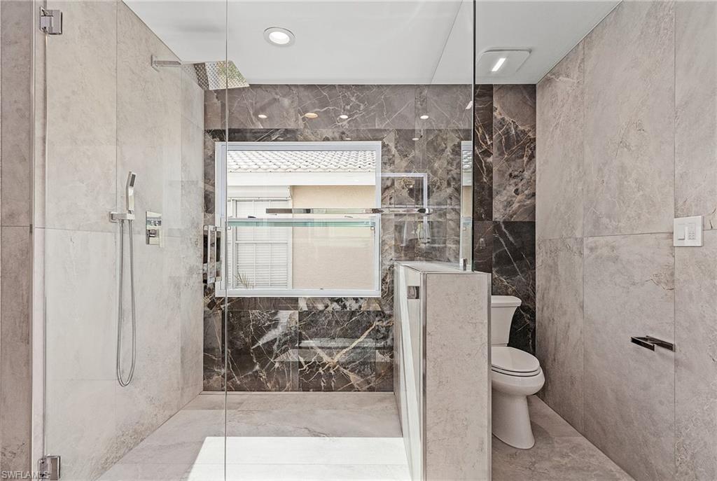 1601 Weybridge Circle, Unit 11 Naples, FL 34110 - Photo 13 of 34 a bathroom with a shower and a toilet