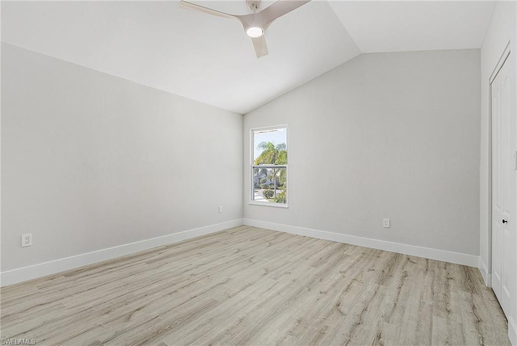1601 Weybridge Circle, Unit 11 Naples, FL 34110 - Photo 15 of 34 an empty room with wooden floor and windows