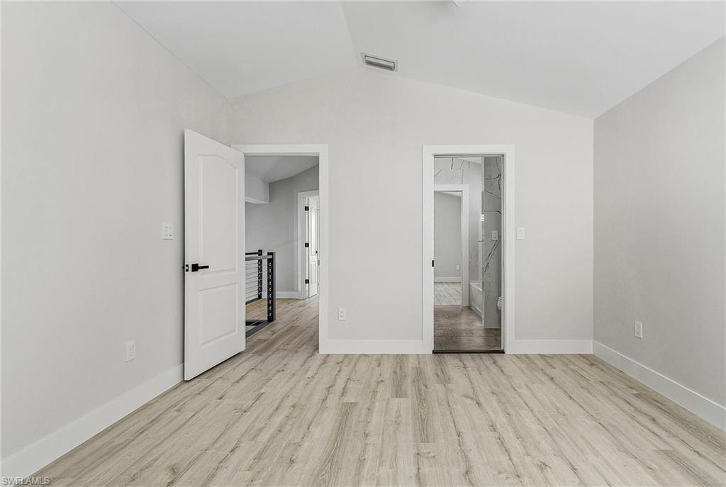 1601 Weybridge Circle, Unit 11 Naples, FL 34110 - Photo 16 of 34 wooden floor in an empty room