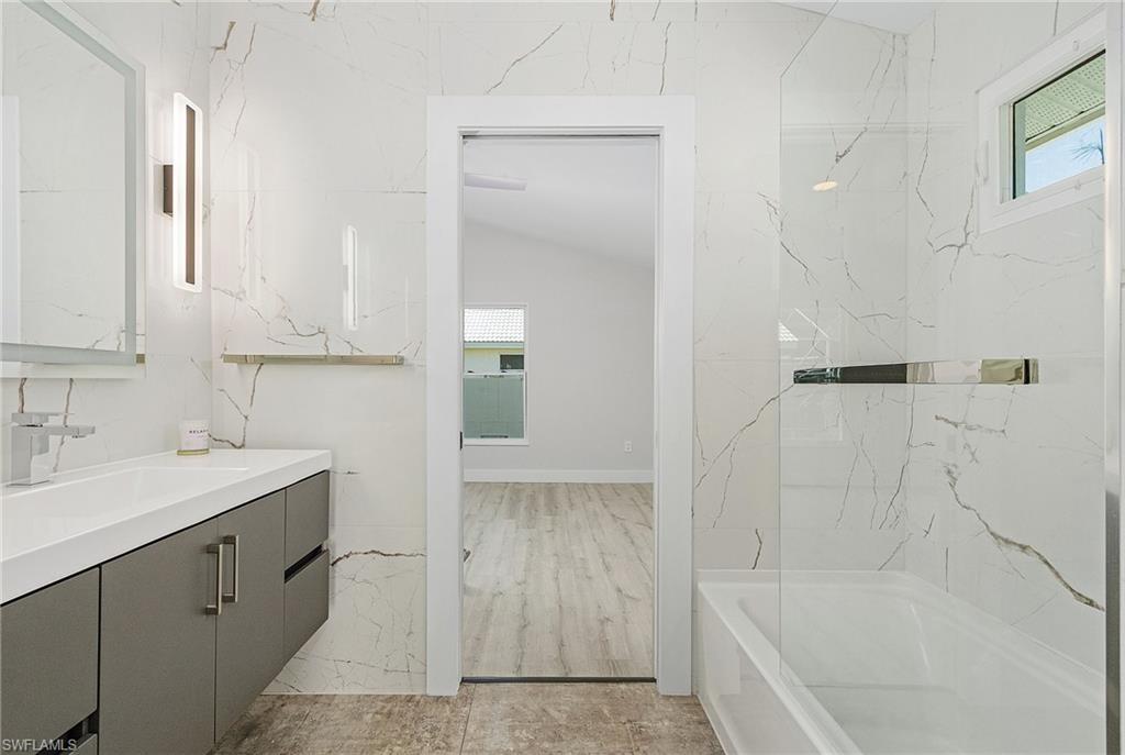 1601 Weybridge Circle, Unit 11 Naples, FL 34110 - Photo 17 of 34 a bathroom with a bathtub and a sink