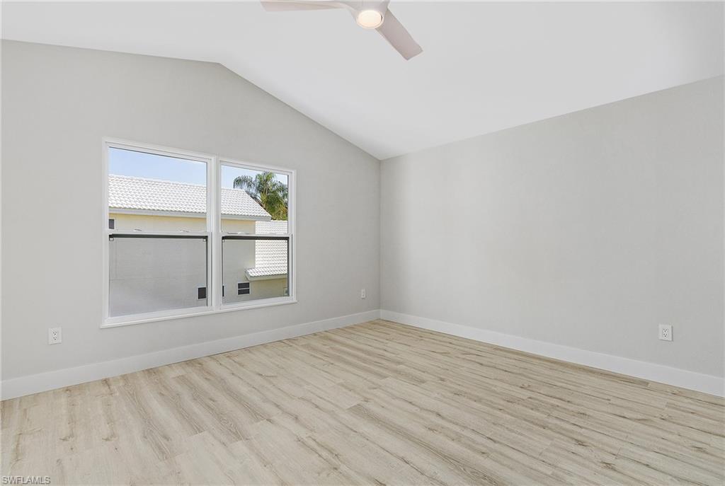1601 Weybridge Circle, Unit 11 Naples, FL 34110 - Photo 18 of 34 an empty room with wooden floor and window