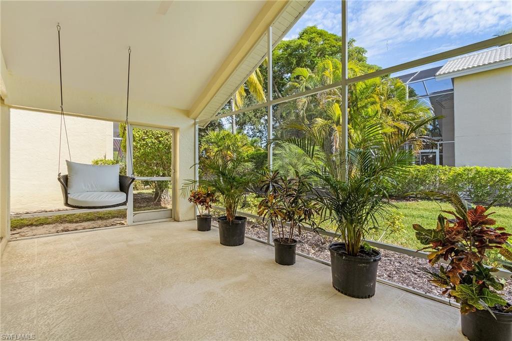 1601 Weybridge Circle, Unit 11 Naples, FL 34110 - Photo 21 of 34 a view of an chair and table in the patio