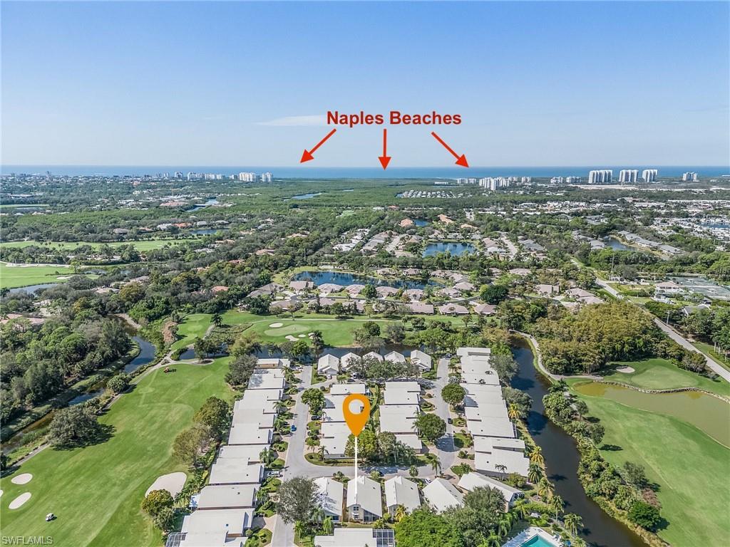 1601 Weybridge Circle, Unit 11 Naples, FL 34110 - Photo 23 of 34 an aerial view of residential building and lake