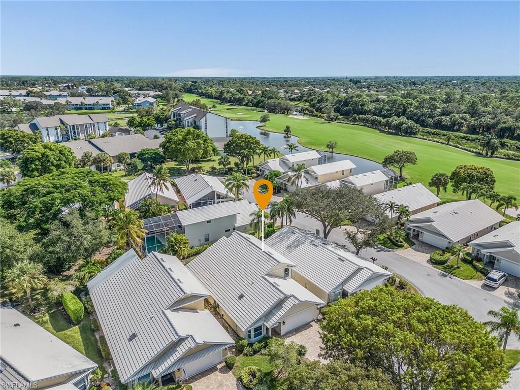 1601 Weybridge Circle, Unit 11 Naples, FL 34110 - Photo 28 of 34 an aerial view of a house with a garden