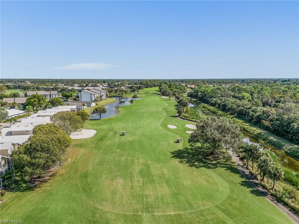 1601 Weybridge Circle, Unit 11 Naples, FL 34110 - Photo 29 of 34 a view of a lake with houses