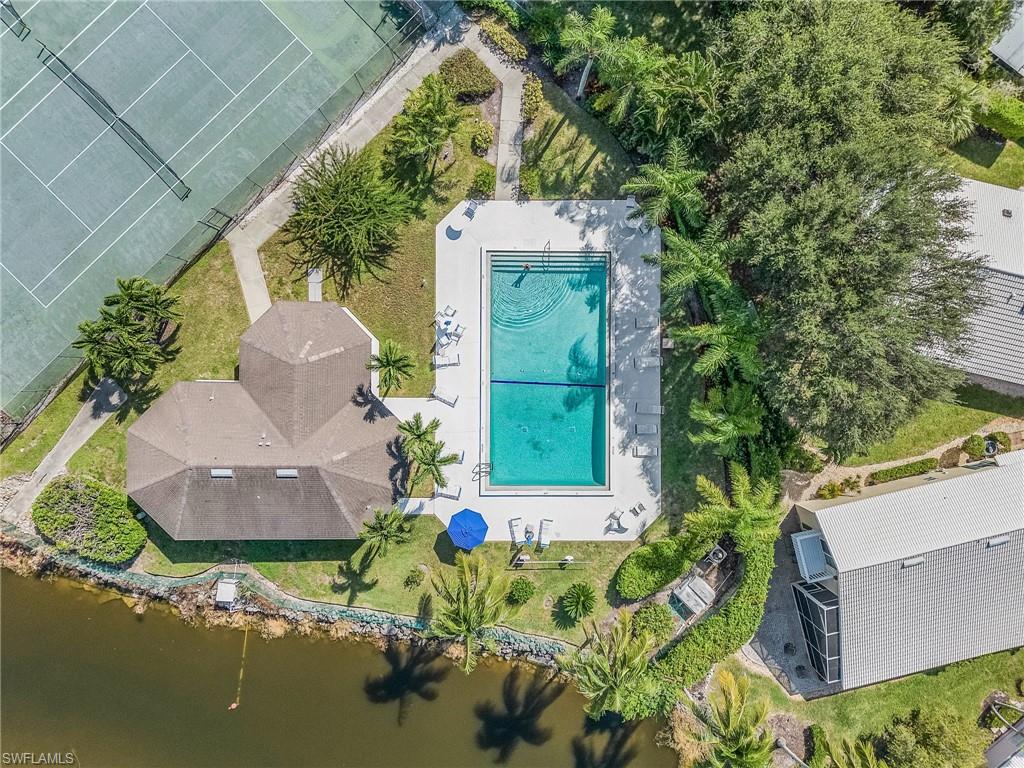 1601 Weybridge Circle, Unit 11 Naples, FL 34110 - Photo 34 of 34 an aerial view of a house with a yard wooden table and chairs