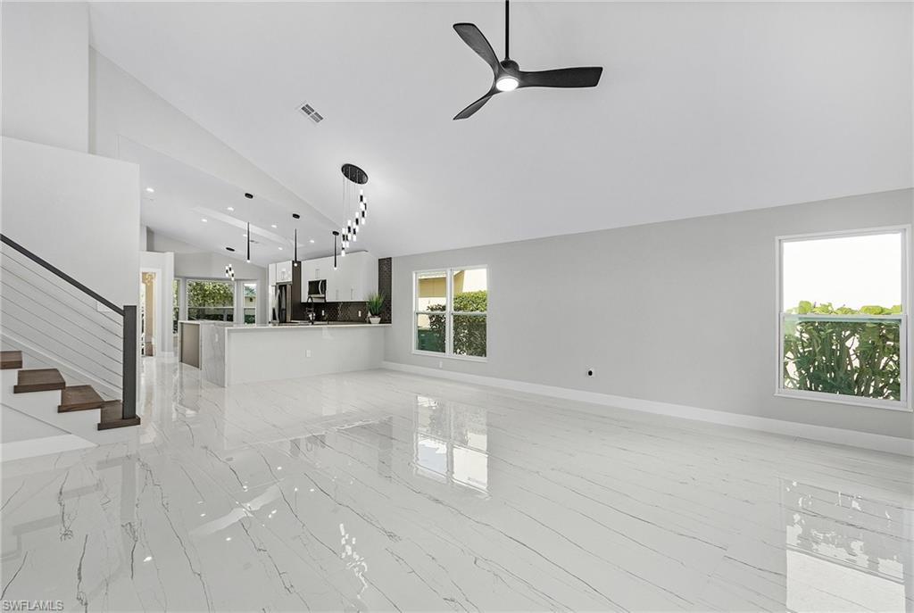 1601 Weybridge Circle, Unit 11 Naples, FL 34110 - Photo 5 of 34 a view of empty room with wooden floor