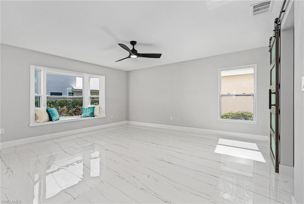 1601 Weybridge Circle, Unit 11 Naples, FL 34110 - Photo 8 of 34 a view of an empty room with a window