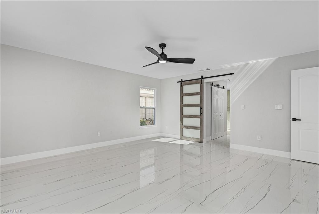1601 Weybridge Circle, Unit 11 Naples, FL 34110 - Photo 10 of 34 a view of an empty room with a window
