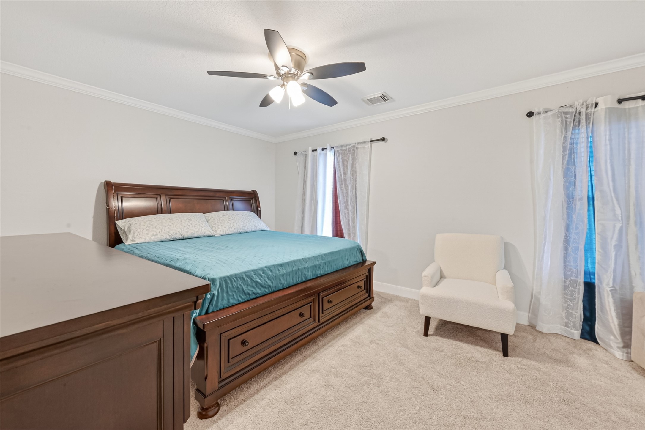 8023 Pool Hill Road Fulshear, TX 77441 - Photo 38 of 50 a bedroom with a bed and a chandelier