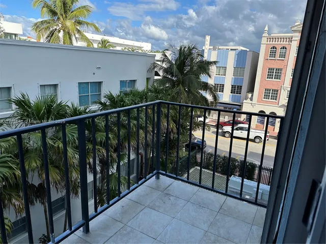 a view of a balcony with potted plants