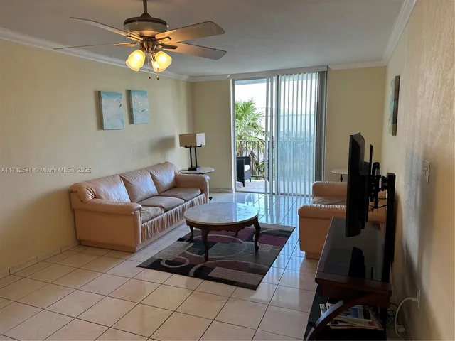 a living room with furniture a chandelier and a window