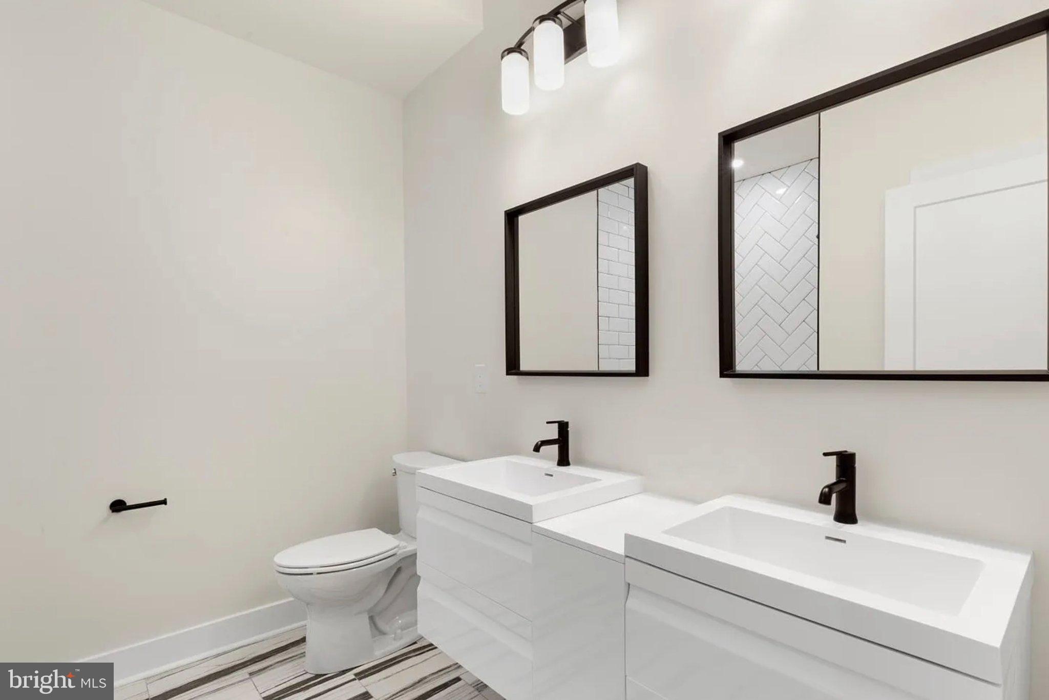2719 Lefevre Street Philadelphia, PA 19137 - Photo 22 of 33 Sleek modern bathroom with dual sinks.