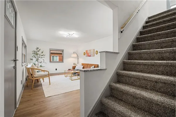 a view of a living room and entryway with wooden floor