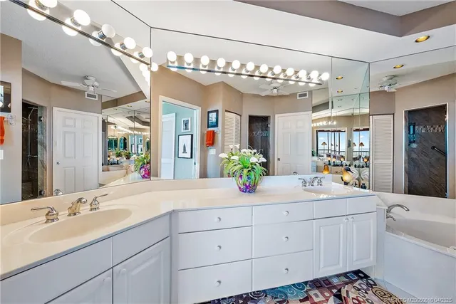 a spacious bathroom with a sink double vanity and a mirror