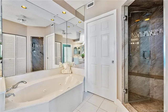 a spacious bathroom with a bathtub and a shower