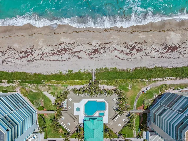 a aerial view of a house with a yard and lake view
